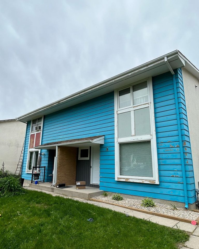 Blue House with White Trims on Windows